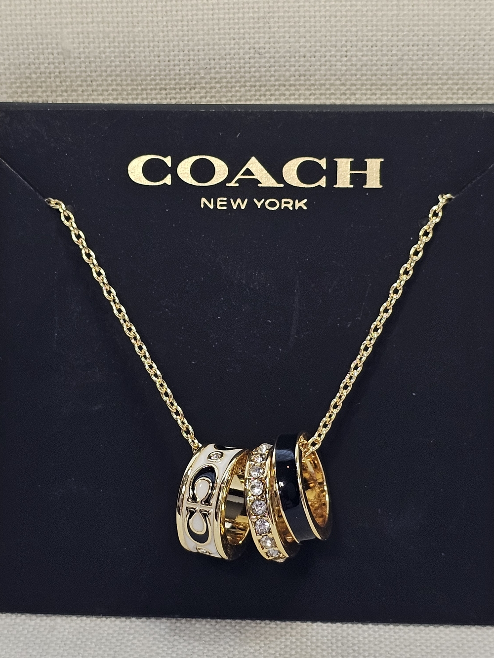 COACH Gold and Black Pendant Necklace with Crystal Accents